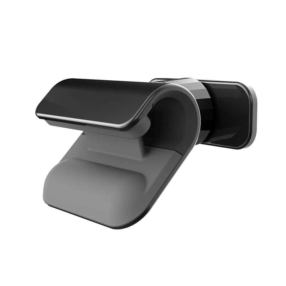 Black gravity car phone holder with 360-degree rotation on a car dashboard
