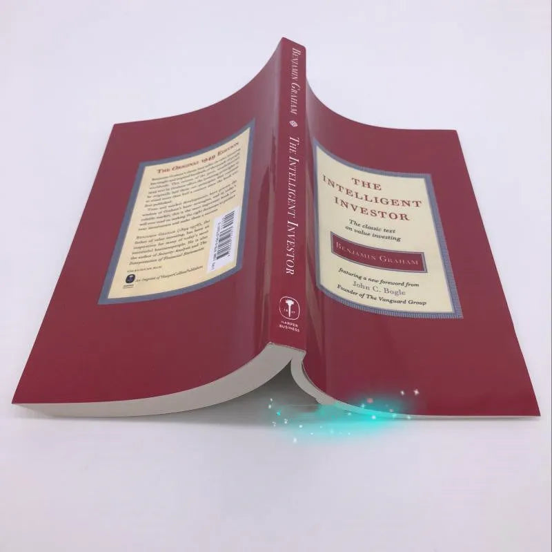 The Intelligent Investor paperback book by Benjamin Graham showing financial investment cover