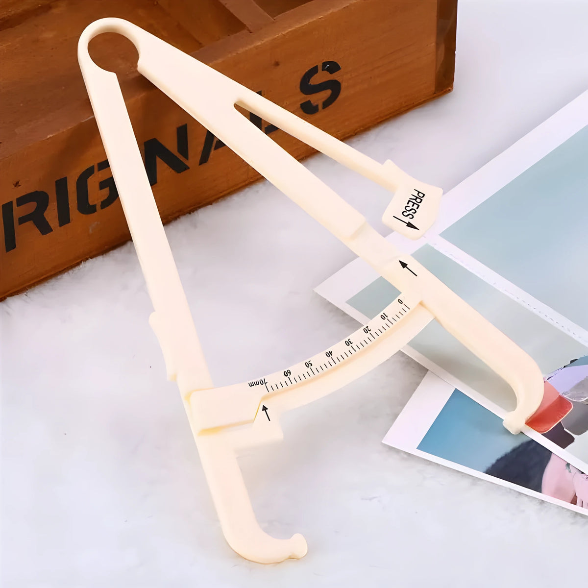 Acrylic fat caliper body fat measuring instrument showing measurement scales and 200mm range