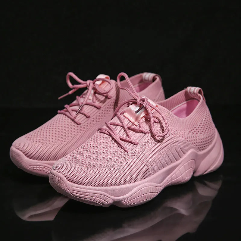 Women's low-top white woven sneakers with thick rubber sole and letter pattern detail