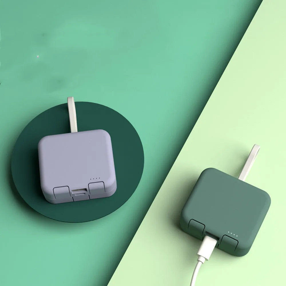 Handbag clip-on power bank in blue with a phone standing upright in its integrated stand.