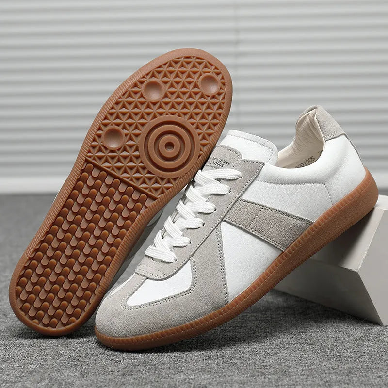 White Japanese-style retro low-top sneakers with round toe and lace-up front on a rubber sole.