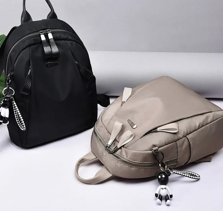 Medium grey Oxford cloth rucksack with double shoulder straps and front digging pocket.