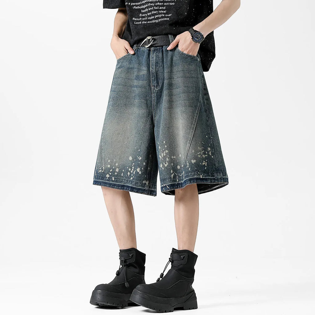 Men's retro washed blue denim shorts with splash ink detailing and ripped accents