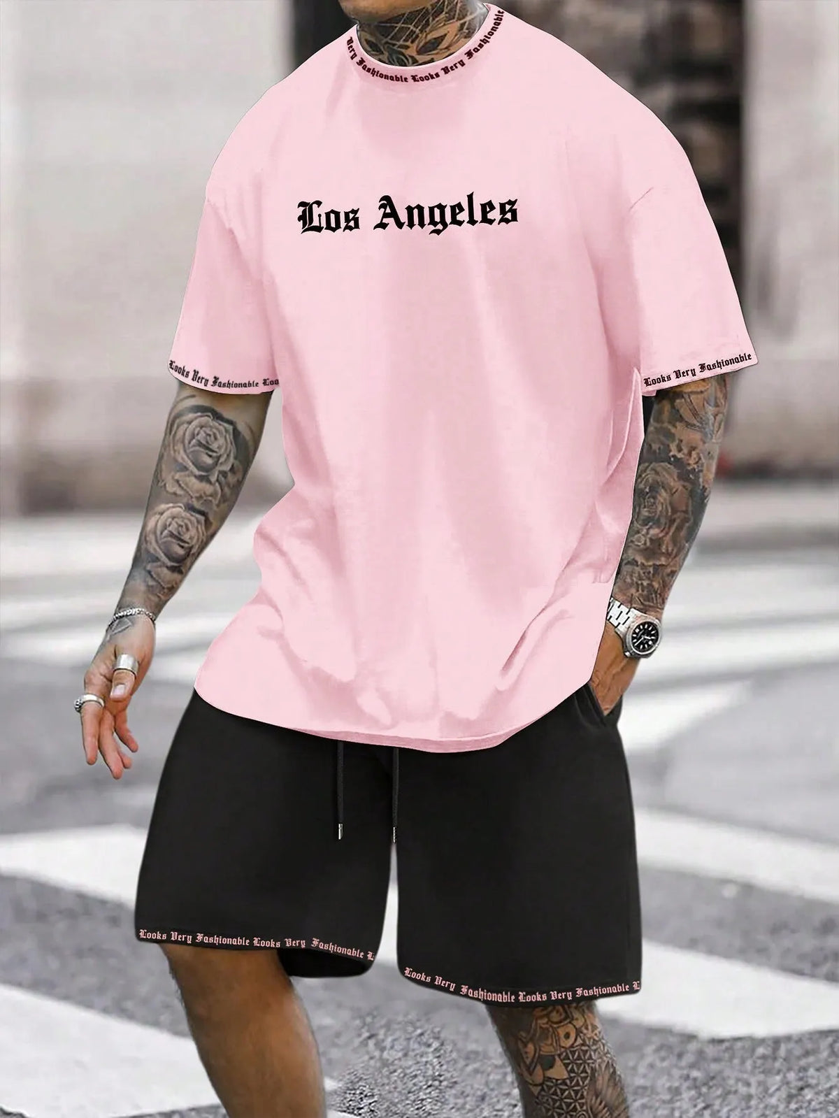 Mens blue sports style short sleeve top and shorts two-piece set on a plain background.