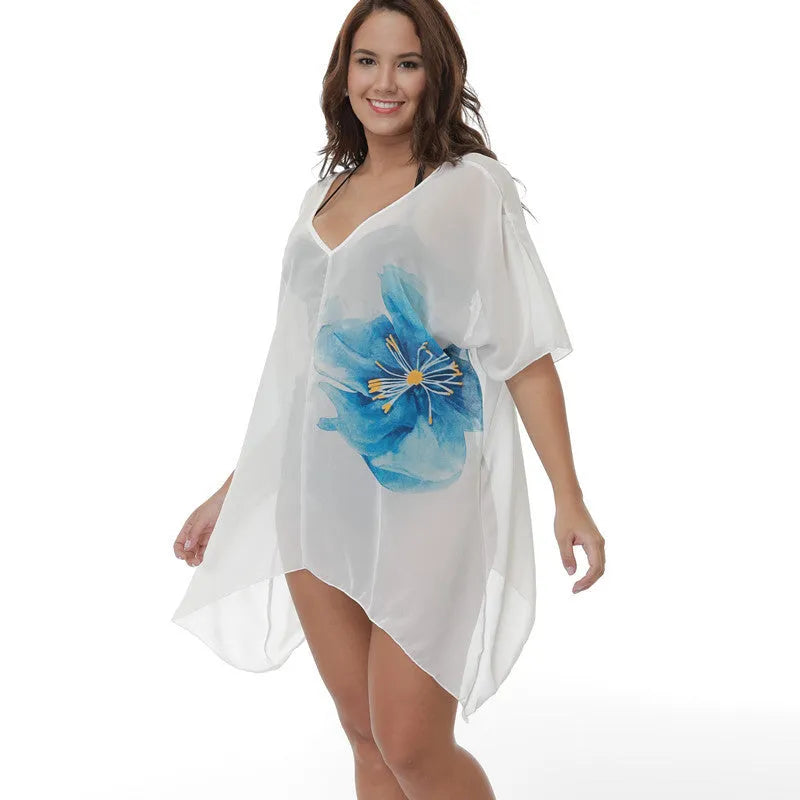 White plus size loose beach cover-up blouse for women on a beach.