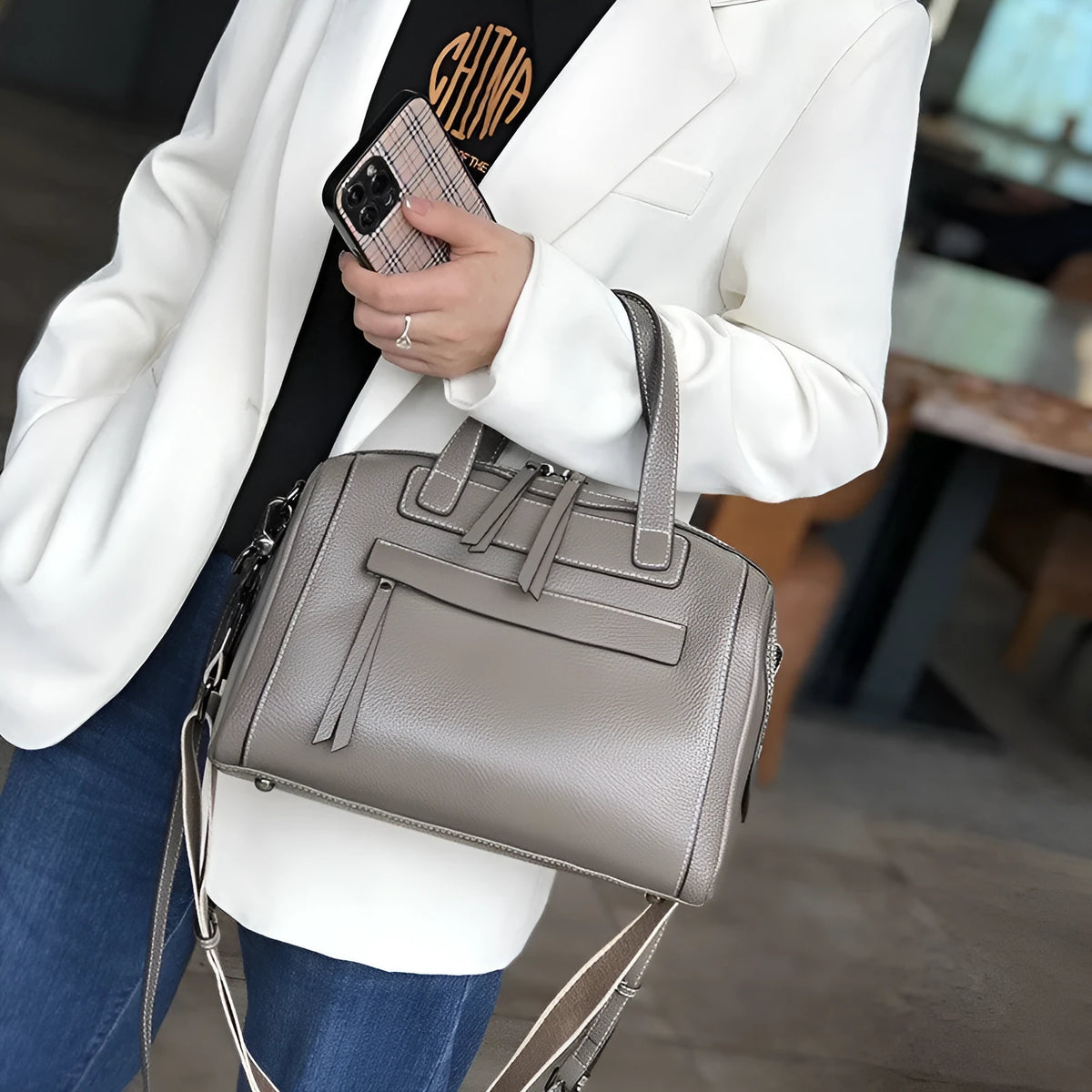 Genuine leather messenger bag with litchi pattern texture in a horizontal square shape.