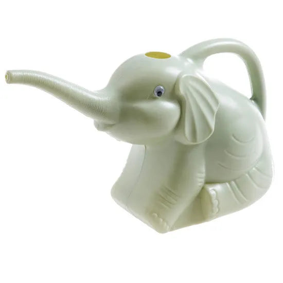Pink baby elephant-shaped plastic watering can with a long spout on a wooden table.