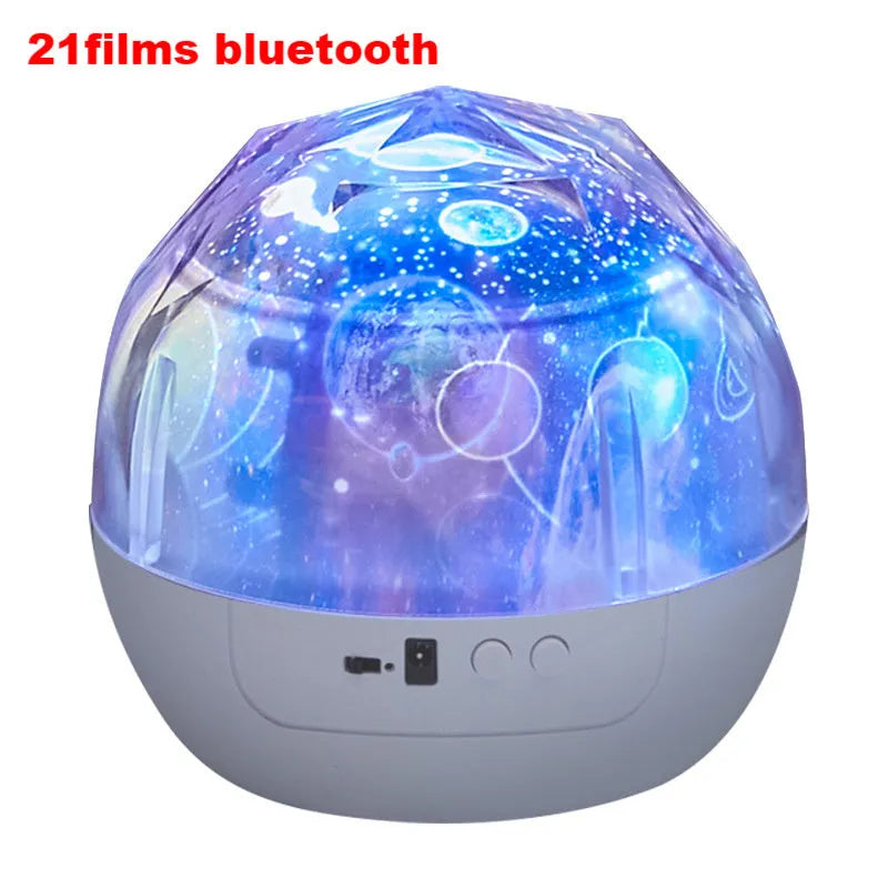 Compact white starry sky projector displaying blue constellation patterns on a dark wall.