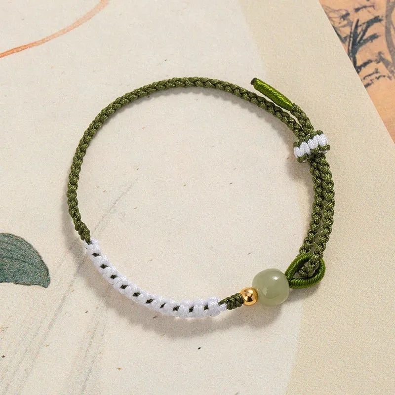 Hetian jade and sterling silver Chinese national bracelet on spring green cord carrying strap