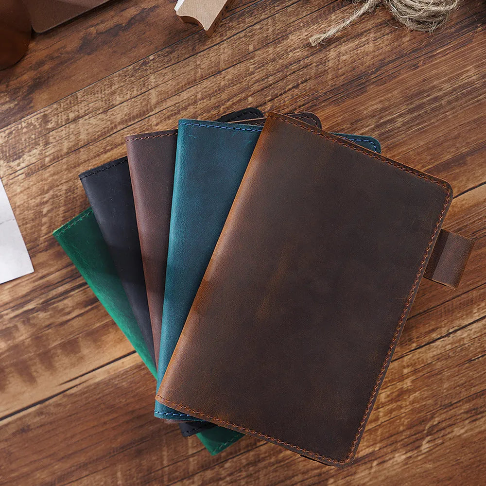 Handmade cowhide notebook with wood-free paper in six colour options showing 9x14cm dimensions