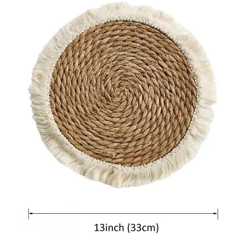 Round Japanese straw placemat with tassel edge on wooden table