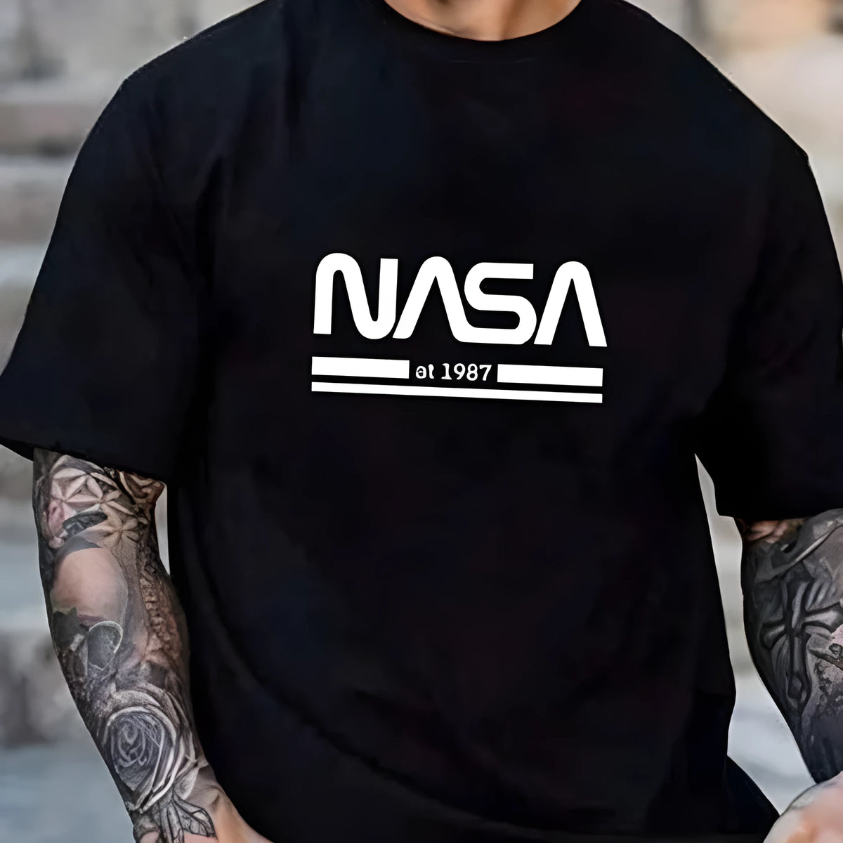 Man wearing a slim-fit apricot coloured cotton T-shirt with a printed letters design on the front.