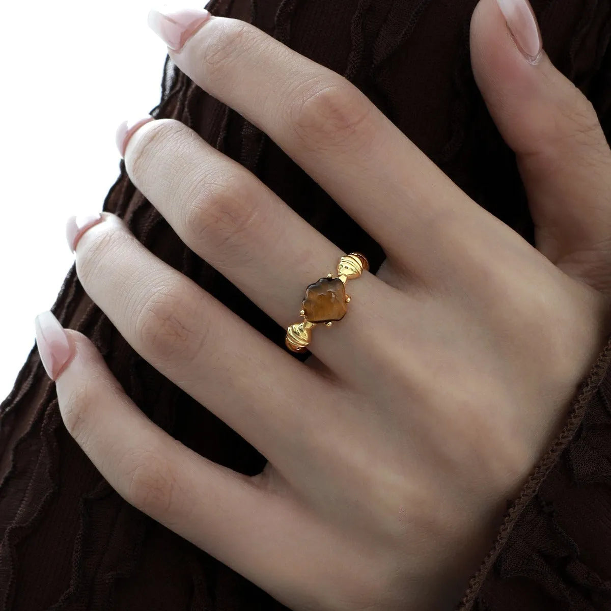 Adjustable silver ring with a white shell and tiger eye design in a choice of gold or white gold finish.
