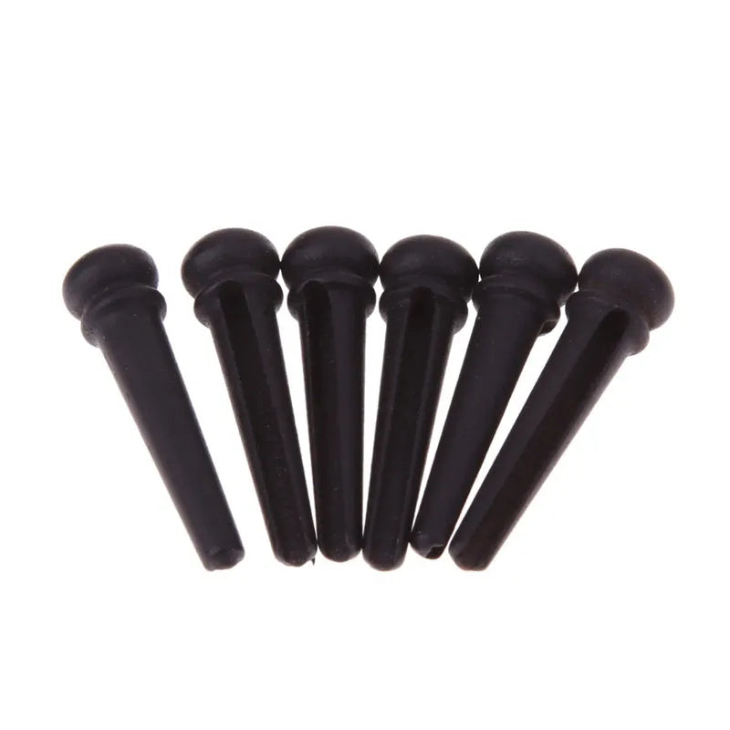 Six matt black ebony guitar string nails with a 5.3mm bayonet diameter for folk acoustic guitars.