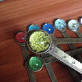 Handmade dried gypsophila, daffodil, and four-leaf clover bookmark on a book page.