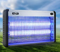 Indoor electric mosquito killing lamp with UV light tube and metal grid for flies.