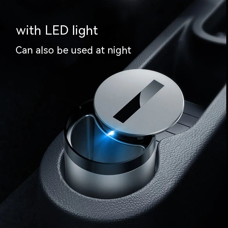 Silver intelligent induction ashtray with automatic lid on a table, showing compact size.
