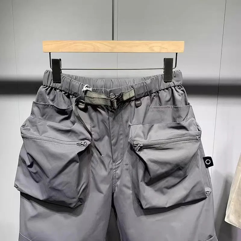 Men's large size work shorts with pockets in black or grey colours showing above knee length and loose fit design