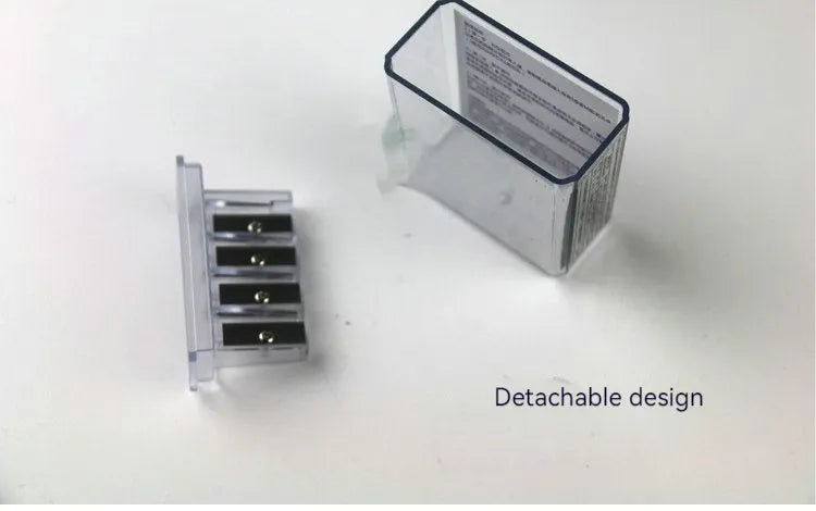 A geometric plastic pencil sharpener with four holes, shown with its integrated screwdriver tool.
