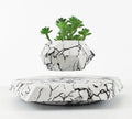 Small marble-colour plastic plant pot floating above a magnetic base unit.