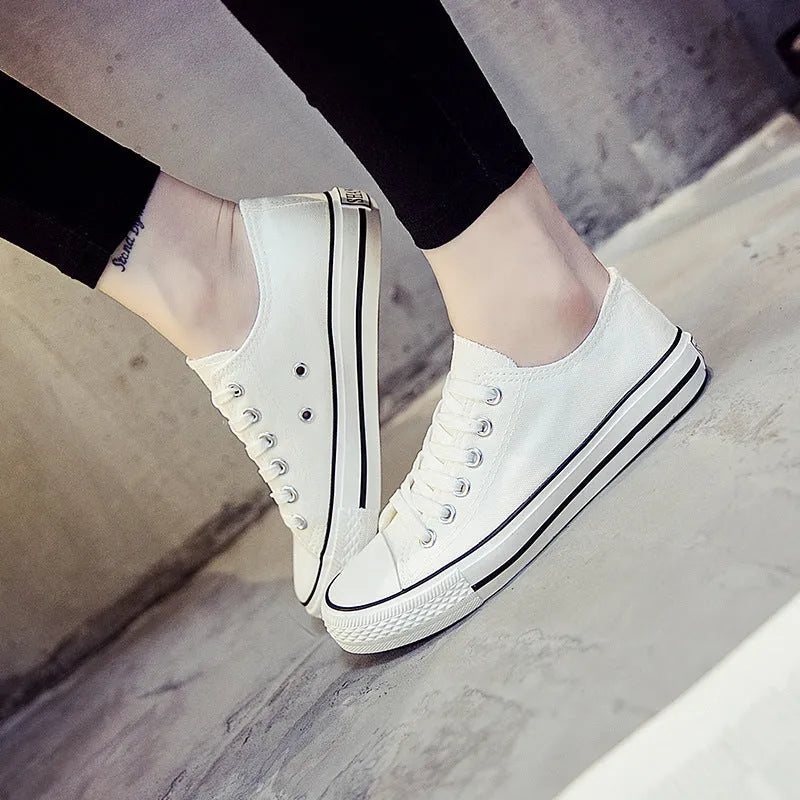 Women's solid-colour canvas lace-up trainers on a white background, showing the casual design and lace detail.