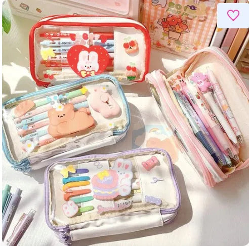 Transparent heart-shaped TPU pencil case in a pink multicolour Korean-style design with cake and rabbit motifs.
