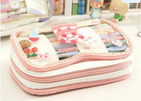 Transparent heart-shaped TPU pencil case in a pink multicolour Korean-style design with cake and rabbit motifs.