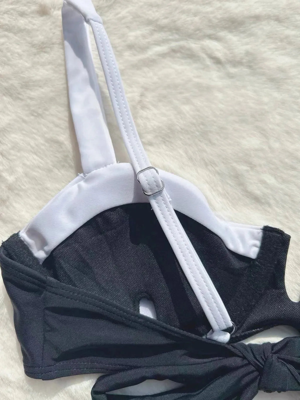 Women's low waist black bikini swimsuit with stitching split detail.