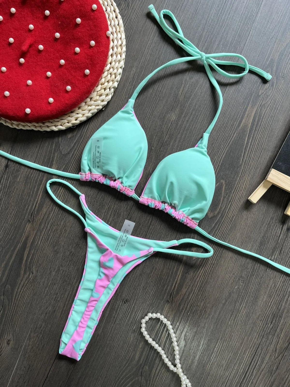 Sexy solid-colour swimsuit with heart print, backless design, and split detail.