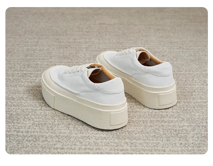 Women's black embossed leather platform sports shoes with a round toe and rubber sole.