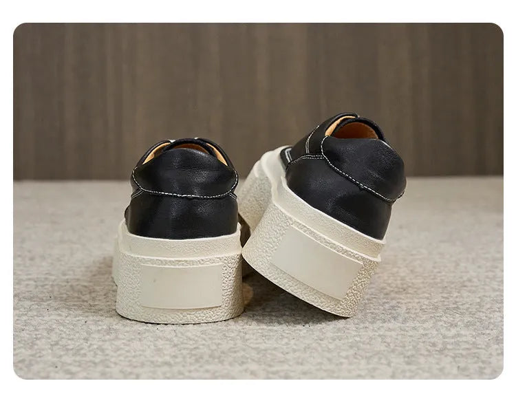 Women's black embossed leather platform sports shoes with a round toe and rubber sole.