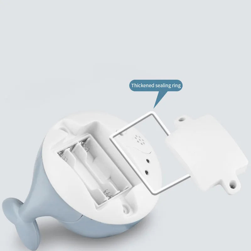 Automatic spray whale baby bath toy with LED lights on a blue base