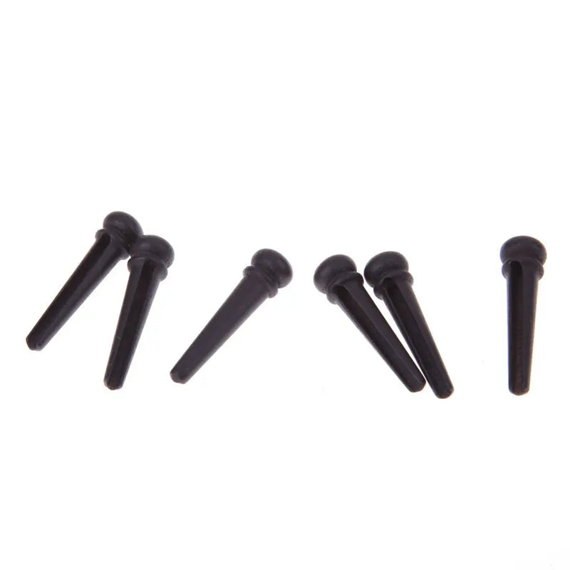 Six matt black ebony guitar string nails with a 5.3mm bayonet diameter for folk acoustic guitars.