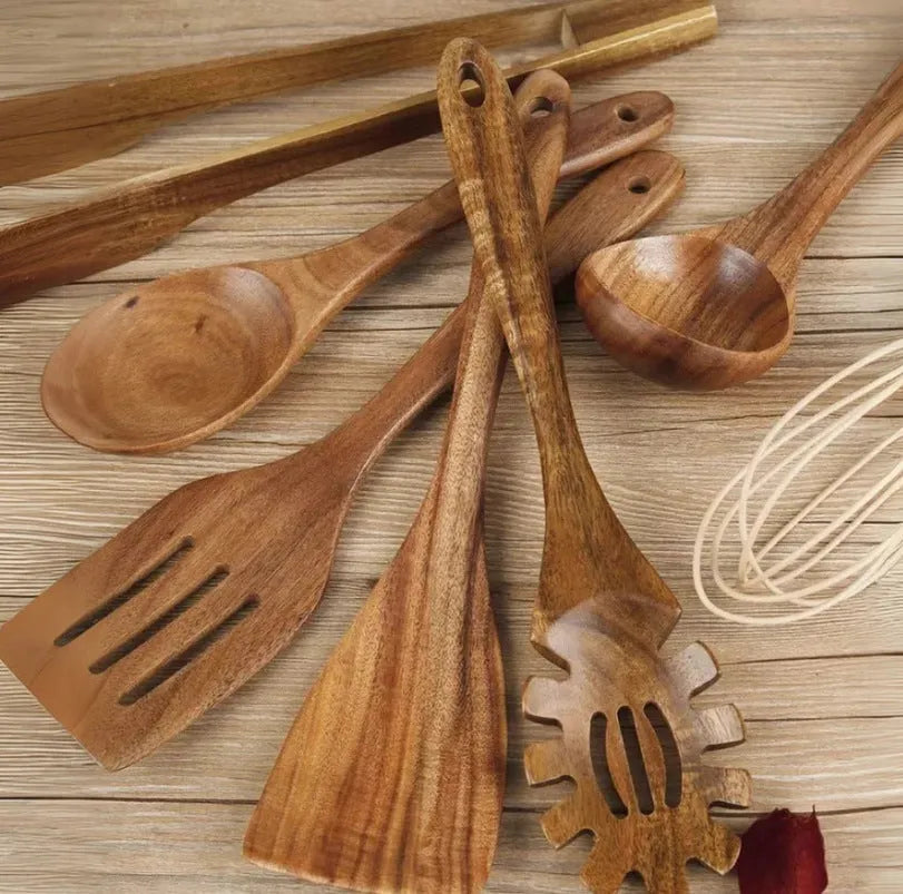 Premium wooden cooking utensils seven-piece set including spoon and spatula on kitchen counter