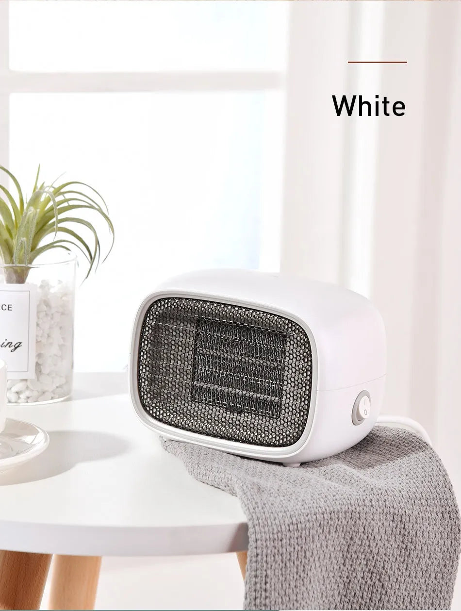 Mini portable electric heater in green colour with compact rectangular design for desk or bedside use