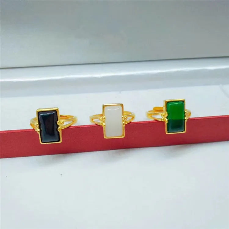 Adjustable brass gold-plated ring with a coloured gemstone in a national style design.