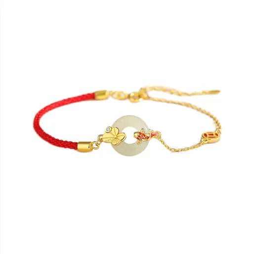Women's silver bracelet with gold koi design and red rope adjustment