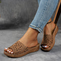 Women's black wedge beach slippers with floral cutouts and an open fish mouth toe design.