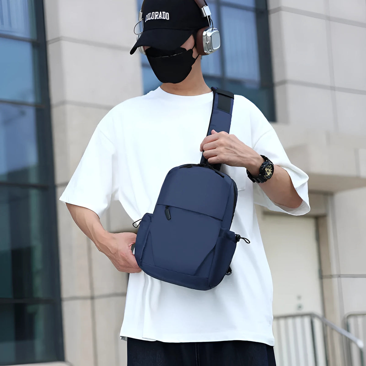 Men's grey waterproof large chest bag with shoulder strap, showing front pocket and main compartment.