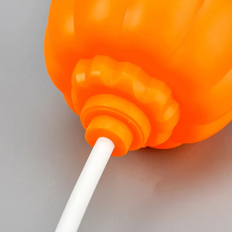 Plastic pumpkin-shaped USB rechargeable lamp glowing with either yellow or purple light, measuring 22cm tall.