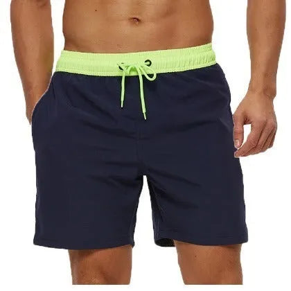 Men's blue drawstring fitness shorts with side pocket and stitching detail on the waistband.
