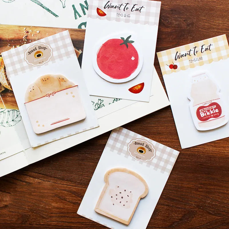 Food themed adhesive note paper pad showing bread, tomato and yoghurt designs, 85mm by 120mm sheet size