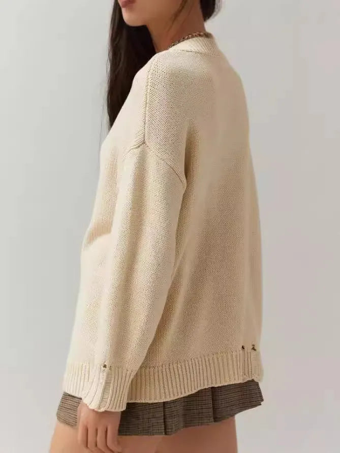 Beige milky white women's acrylic jacquard knit pullover sweater with round neck and long sleeves.