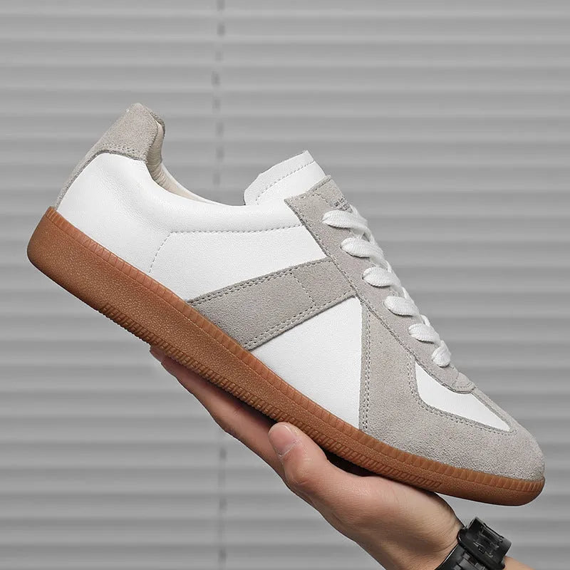 White Japanese-style retro low-top sneakers with round toe and lace-up front on a rubber sole.