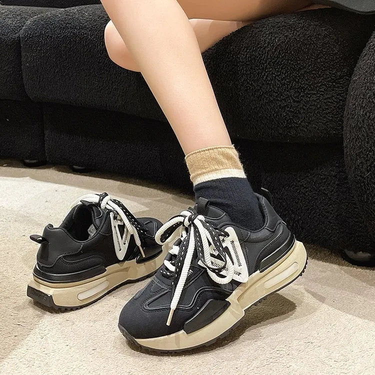 Women's black retro platform sports shoes with round toe and lace-up fastening on a rubber sole.