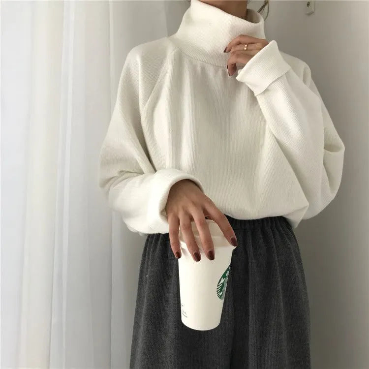 Women's solid colour long sleeve top with a half-high collar shown in a loose fit.