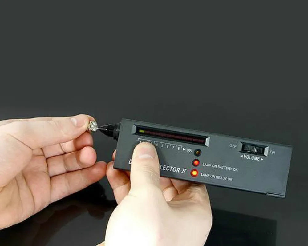 Black handheld second generation diamond thermal conductivity meter on a grey background.