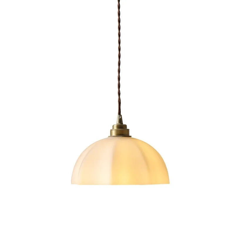 Brass Chinese style pendant light with copper glass shade hanging from ceiling