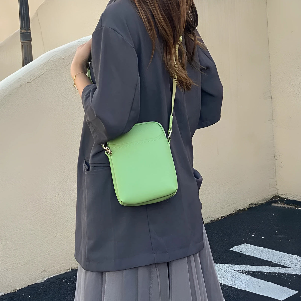Solid colour PU leather mobile phone crossbody bag showing compact size and shoulder strap.